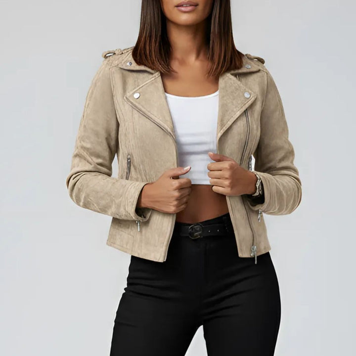 Beieg suede jacket worn by a women on a plain background
